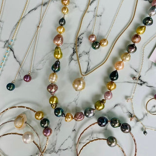 Collection of colorful pearl jewelry arranged artistically, showcasing the custom order process for unique designs.