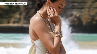 Woman wearing jewelry at the beach, illustrating how to protect jewellery from beach weather.