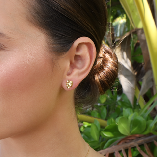 Fine jewelry pearl earrings featured on a model in a tropical setting, showcasing elegance and style.