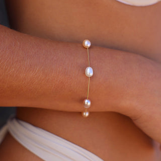 Model wearing Mari multicolor pearl bracelet in 14kt gold by Misha Hawaii