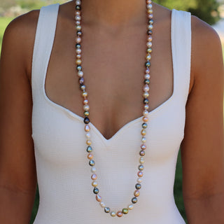 Woman wearing 38 inch rainbow pearl rope strand at the collarbone, Misha Hawaii
