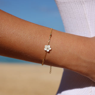 Woman wearing plumeria mother of pearl bracelet Misha Hawaii