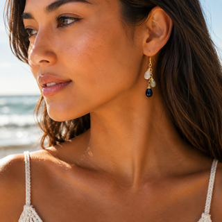 Ocean Ombré Gemstone Earrings showcased on model by the beach, highlighting quartz gemstones and gold-filled details.