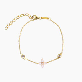 Gold bracelet with a central white mother of pearl gemstone on a white background
