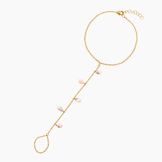 A delicate gold chain hand chain featuring a long drop line with five small cone shells  displayed on a clean white background.