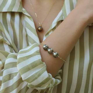 Triple Tahtian Peacock Pearl Bangle in Gold handcrafted in Hawaii on wrist