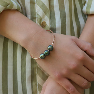 Triple Tahtian Peacock Pearl Bangle in Gold handcrafted in Hawaii on wrist