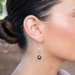 Tahitian black pearl earring with green gemstones on model