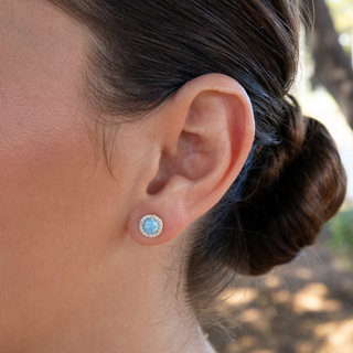 Opal Halo Stud Earrings in gold on ear