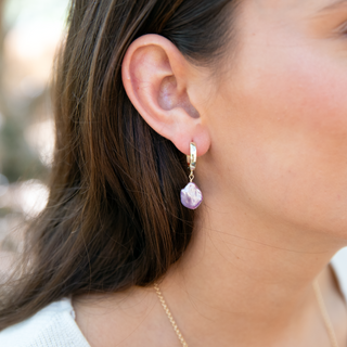 Close-up of a model wearing Pink Keshi pearl huggie earring in gold