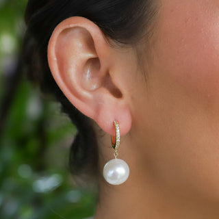 White Pearl Huggies in Gold on ear