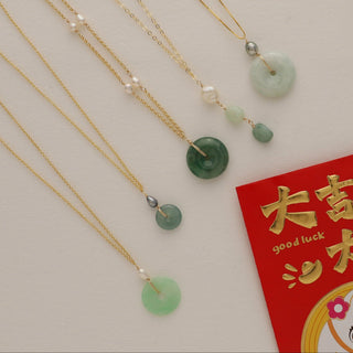 Willow jade keshi pearl necklace alongside jade and pearl pendant necklaces on display.