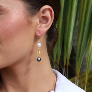 Tahitian pearl and golden south sea pearls on gold leverback earrings on a model