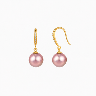 A pair of gold drop earrings featuring a single pink freshwater pearl and a curved gold hook with small clear stones, shown on a plain white background.