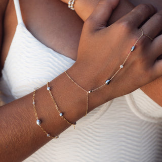 Model wearing a Tahitian pearl hand chain with ring and bracelet, handcrafted in Hawaii