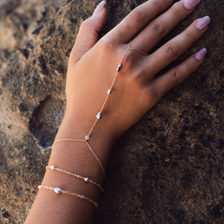 Model wearing a Tahitian pearl hand chain with ring and bracelet, handcrafted in Hawaii