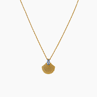 Gold necklace with a shell pendant and blue gemstone on a white background
