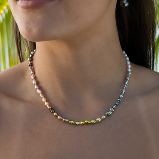 Rainbow keshi pearl strand in 14k gold on model