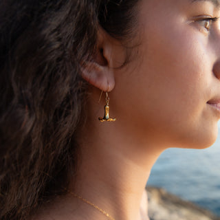 Close up in model Puakenikeni flower earrings in gold handcrafted in Hawaii