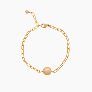 Gold bracelet with a single golden south sea pearl on a white background