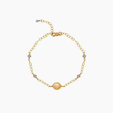 Load image into Gallery viewer, Gold bracelet with a golden south sea pearl and aquamarine gemstones on a white background