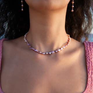 Pink Keshi Pearl Strand showcasing an elegant design with pink and white keshi pearls worn by a model.