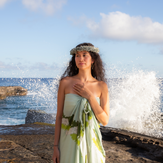 Tahitian pearl hand chain with ring and bracelet on model in front of the ocean