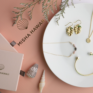Jewelry set with 'Misha Hawaii' branding on a pink background