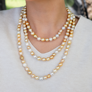 Golden south sea pearl strand with gold clasp on model