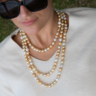 Golden south sea pearl strand with gold clasp on model