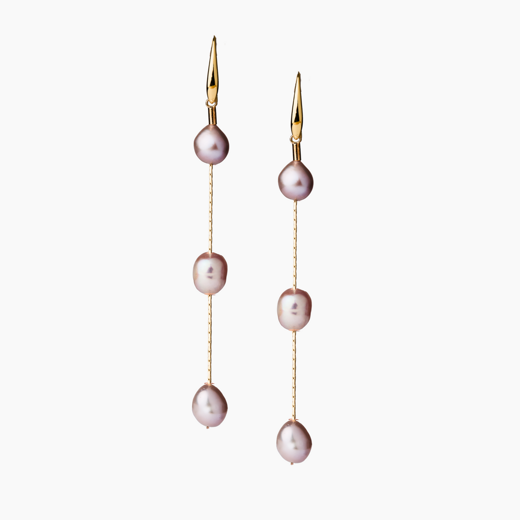Pair of pearl earrings with gold hooks on a white background