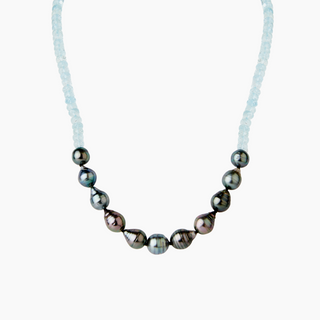 Necklace with tahitian dark pearls and aquamarine on a white background