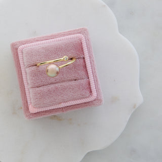 pink pearl ring in gold in a jewelry box