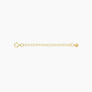 A delicate gold chain extender bracelet featuring a lobster clasp on one end and a small polished ball charm on the other, displayed horizontally against a solid white background.