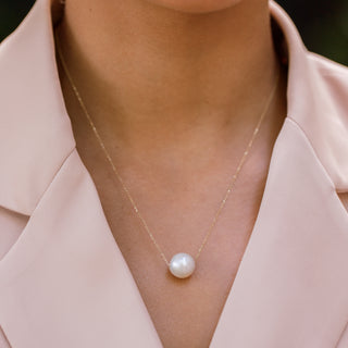Woman wearing floating white pearl necklace, Misha Hawaii