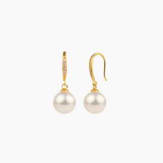 Pair of pearl earrings with gold hooks on a white background