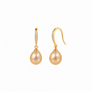 A pair of gold drop earrings featuring teardrop-shaped pearl-like beads and a small row of clear stones along the upper hook, shown on a plain white background.