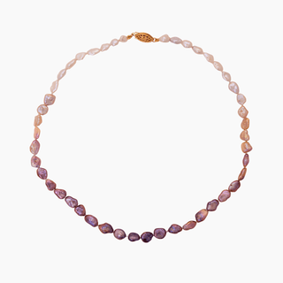 Ombré pink keshi pearl strand featuring pink and white freshwater keshi pearls, hand-knotted for elegance and strength.