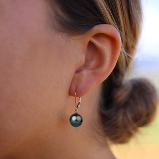  Tahitian black pearl drop earrings in gold handcrafted in Hawaii on model