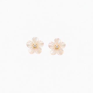 A pair of small flower-shaped stud earrings with glossy cream petals and a tiny clear stone in the center, shown on a plain white background.