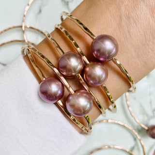 Pink pearl bangle in gold made in Hawaii on wrist