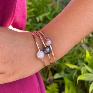 baby pink pearl bangle in gold made in Hawaii on wrist