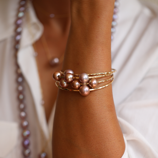 Pink pearl bangle in gold made in Hawaii on wrist