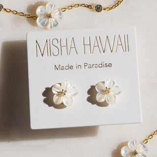 Flat lay of Pua mother of Pearl flower studs in gold 