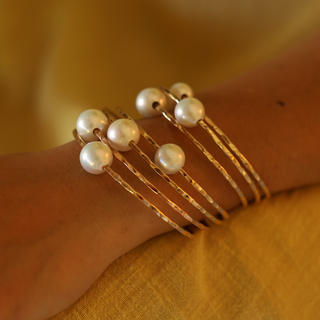 White pearl bangle in gold made in Hawaii on wrist