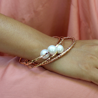 White pearl bangle in gold made in Hawaii on wrist